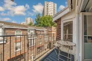 a balcony with a chair on a building at ELGIN MEWS NORTH beside Maida Vale tube and parking LONG TERM BOOKINGS in London