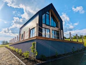 a house with glass windows on the side of it at Wichrowy Domek Nowy Targ - Podhale - Tatry - Gorce - Balia in Nowy Targ