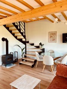 a living room with a staircase and a glass table at Wichrowy Domek Nowy Targ - Podhale - Tatry - Gorce - Balia in Nowy Targ