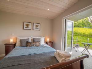 a bedroom with a bed and a large window at Kites Nest-Qu7488 in Highgate
