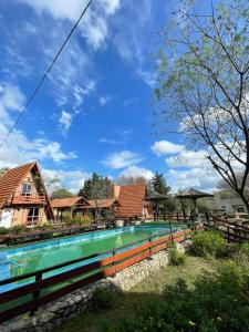 a swimming pool in front of some houses at Alpinas San Lorenzo in Merlo