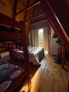 a bedroom with two bunk beds in a cabin at Alpinas San Lorenzo in Merlo