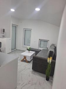 a living room with a couch and a table at Apartman Centar Visegrad in Višegrad