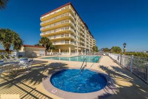 a large building with a swimming pool next to a building at Waterfront Resort , World Class Marina & Slip in Beaufort