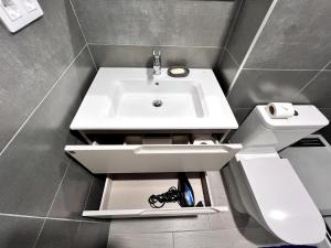a bathroom with a sink and a toilet at Top apartment! in Benajarafe +14 photos