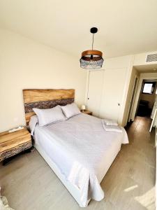 a bedroom with a large white bed in a room at Top apartment! in Benajarafe