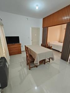 a bedroom with a table and a bed and a television at Balcarce Suite in Villa Mercedes