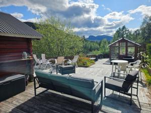 a patio with chairs and a table and a gazebo at Holiday Riverside Beach Camping in Gol