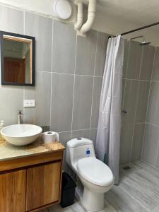 a bathroom with a toilet and a sink and a shower at Finca El Encanto in Jericó +19 photos