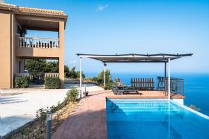 a house with a swimming pool and a view of the ocean at Villa sea view 1 in Athanion