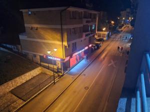 a view of a street at night with a building at Apartman Centar Visegrad in Višegrad +2 photos