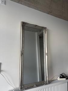 a mirror on a white wall in a room at ØSV Odense C in Odense +1 photo