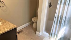 a bathroom with a toilet and a shower curtain at Bayside Beauty in Town Bank +28 photos