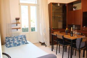 a room with a table and chairs and a bedroom at Angel's Como Lake Apartment in Como