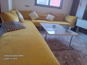 a couch and a coffee table in a living room at Agréable maison in Agadir
