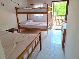 a room with two bunk beds and a balcony at Borealis Apartahotel Tolú in Tolú