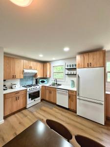 a large kitchen with white appliances and wooden cabinets at Sun & Sand Resort in Port Austin
