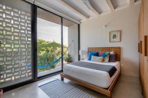 a bedroom with a bed and a large window at Hola Donceles Suites in Cancún +45 photos