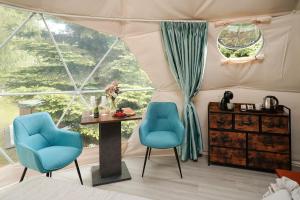 a room with two chairs and a table and a window at Glamping Lužec in Nejdek
