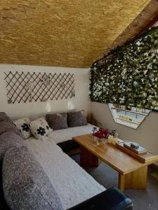 a living room with two beds and a table at Apartment Dil in Kulen Vakuf