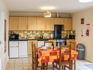 a kitchen with a table and chairs in a room at Arenig - Uk48508 in Bala
