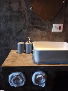 a bathroom with a sink and a counter with towels at Villa Mantiqueira - Studio II - Com lareira e área verde in Campos do Jordão +20 photos