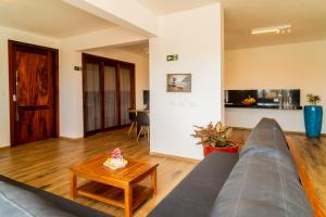 a living room with a couch and a table at Aiolos Hotel & Discoveries in Prea