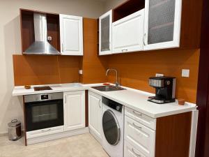 a kitchen with white cabinets and a sink at Miramar Palace 612S in Sunny Beach