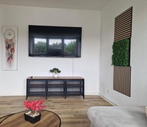 a living room with a table and a window at Grimm Apartment in Kassel