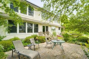 a patio with chairs and a table in front of a house at Peaceful Countryside Retreat with Yard in Frenchtown in Frenchtown