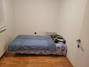 a small bed in a corner of a room at Apartma Dejan in Semedela