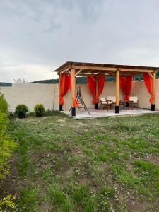a gazebo with a picnic table and a view of the water at h’Olarooms N3 in Tʼianetʼi