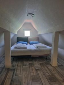 a bed with blue pillows in a room at Vikendica Artos in Bihać +8 photos