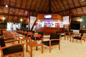a restaurant with tables and chairs and a bar at Adaaran Club Rannalhi - All Inclusive - 45 Minutes away from Male by Speedboat in South Male Atoll