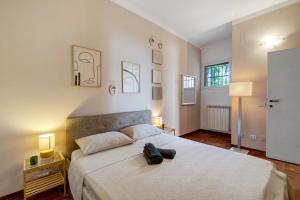 a bedroom with a large bed with a pair of shoes on it at Casa Della Baia With a beautiful view in Varazze +53 photos