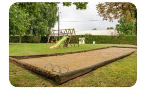 a playground with a slide in a park at GITE Thiron Gardais LA COUR aux PAUVRES in Thiron-Gardais