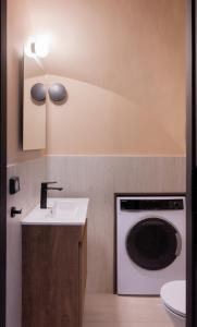 a bathroom with a washing machine and a sink at Tproject in Preveza +54 photos