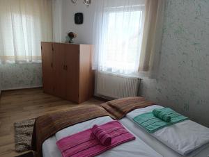 a bedroom with a bed with two towels on it at Apartment SAFIR Sarajevo- Free parking in Sarajevo