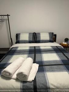 a bed with two pillows and towels on it at Family-Friendly 4BR Retreat Fully Furnished in Sarnia +7 photos