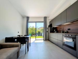 a kitchen and dining room with a table and a couch at Appartamenti Ciliegio & Ulivo in Dongo
