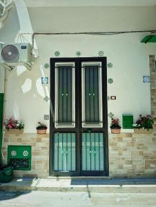 a door on the side of a building with potted plants at A meravigghia Casa vacanze in Bagheria
