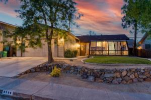 a house with a stone wall in front of a house at Reno Retreat-Near Downtown-UNR-Family Fun in Reno