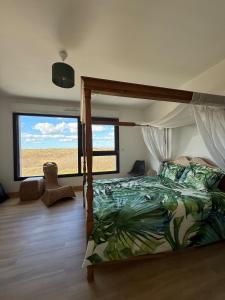 a bedroom with a bed and a large window at la maison de la mer in Port-Bail-sur-Mer +37 photos