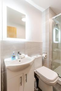 a white bathroom with a toilet and a sink at Spacious 2Bed Central Liverpool Nightlife & Events, sleeps up to 10 in Liverpool +15 photos
