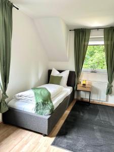 a bedroom with a bed and a window at Haus am Wald mit Whirlpool, Garten, Kamin und voll ausgestatteter Küche in Stolberg +155 photos