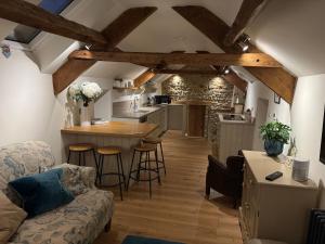 Una sala de estar con un sofá y una cocina. en Rawcliffe Barn, 2 Bedroom, up to 4 Guests, en Newton 8 fotos más