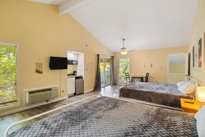 a hotel room with two beds and a television at Osage Oasis- C in Osage Beach