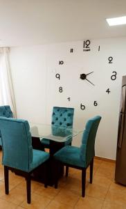 a glass table with chairs and a clock on the wall at Hospedaje,Cartagena,Clasicos,Turismocolombia-fit in Cartagena de Indias