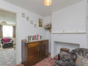 a living room with a couch and a fireplace at Bank Top Cottage in Hathersage