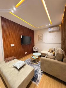 Habitación con 2 camas, sofá y TV. en Luxury suite T2, Mamelle, Dakar, Sénégal, en Dakar
